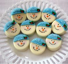 frosted snowman cookies on a white plate