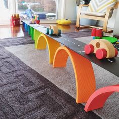 a child's play table with colorful wooden toys on it in a living room