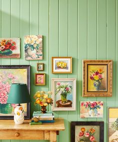 there are many pictures on the wall with vases and flowers next to each other