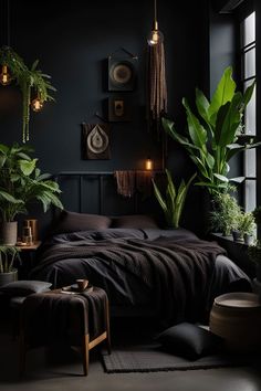 a bedroom with dark walls and plants in the corner