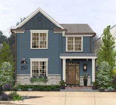 a blue two story house with white trim on the front door and windows, surrounded by greenery