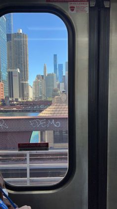 a view from the inside of a subway car looking out at a cityscape