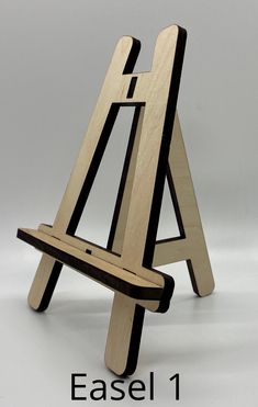 a wooden easel sitting on top of a white table