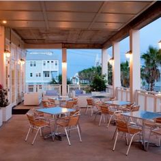 tables and chairs are set up on the porch