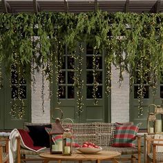 an outdoor patio with wicker furniture and greenery