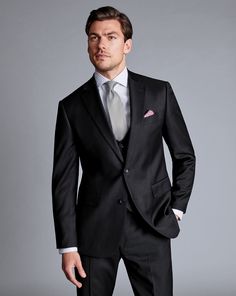 a man in a black suit and tie