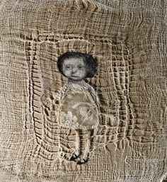 an image of a piece of cloth with a doll on it's head and some crinkled fabric around the edges