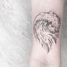 a small wave tattoo on the arm