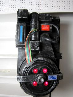 an electrical device with wires attached to the back of it's housing and two red lights on each side