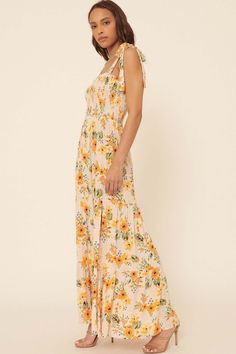 Floral-print crepe maxi dress. Straight neckline with ruffle. Smocked bodice. Sleeveless with tied shoulder straps. Low back. Side slit. Tiered ruffle skirt. High waist. Ankle length. Fit and flare silhouette. 100% Rayon. Imported. Designed in LA. Model wears size S. Crepe Maxi Dress, Smocked Maxi Dress, Tiered Ruffle Skirt, Skirt High Waist, Straight Neckline, Ruffle Skirt, Floral Maxi, Low Back, Floral Maxi Dress