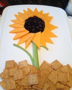 a sunflower made out of crackers on a plate