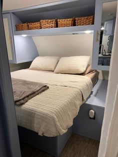 there is a bed that has been built into the wall with shelves on each side