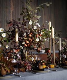 a table topped with lots of flowers and candles