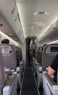 the inside of an airplane with people sitting on seats