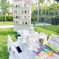 the table is set up outside with many items on it, including markers and pencils