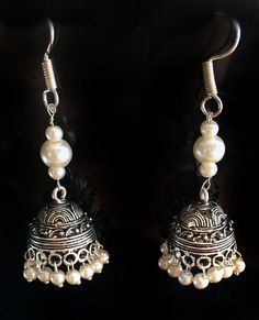 PEARL JHUMKA EARRINGS Jhumkas are the calling on the runway ramps this year. This is a traditional artist Jhumki handmade with love. Finished up with beautiful white pearls , A very hot pair for this season. The length of the earrings is 2.5 inches from top to the tip of the earring. lightweight ' If you want unique this season then these are a pair you must own. wear temple art and become a part of rich tradition. Thank you for your support Go back to Storefront Taneesijewelry.etsy.com View my Luxury Temple Jewelry Jhumkas With Latkans, Cheap Silver Temple Jewelry Earrings, Elegant Jhumkas For Festive Occasions, Elegant Heavy Jhumkas For Festival, Elegant Festival Jhumkas, Elegant Silver Jhumkas For Festival, Silver Jhumkas With Latkans For Festival, Silver Jhumkas For Festival, Silver Jhumkas For Navratri Party