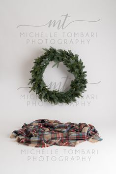 a wreath and plaid blanket on a white background with the word mr michael tombarii photography