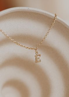 Is there anything sweeter than a tiny single initial? We don’t think so! 8 x 6mm uppercase block letter is suspended from delicate cable or scout chain. Offered in 16" or 18" lengths. Available in 14kt Gold Fill + Sterling Silver. Kayla layers it with our Pearl Linked Necklace. Handmade in Eau Claire, WI. Our jewelry is handmade so each piece will be unique and may vary slightly from what is pictured. Initial Pendant Necklace With Cable Chain, Everyday Tiny Initial Pendant Charm Necklace, 14k Gold Initial Necklace With Cable Chain For Everyday, Everyday 14k Gold Initial Pendant Name Necklace, Simple 14k Gold Initial Pendant Charm Necklaces, Simple 14k Gold Initial Pendant Charm Necklace, Everyday Initial Monogram Necklace In 14k Gold, 14k Gold Filled Initials Charm Necklace For Everyday, 14k Gold Monogram Initial Necklace For Everyday