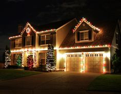 a house is decorated with christmas lights and garlands