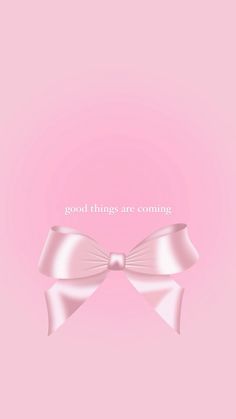 a pink bow with the words good things are coming in white lettering on it, against a pale pink background