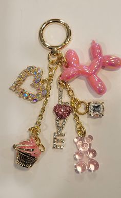 This listing is for a rhinestone pink ballon dog gold bag charm. It is just about 5 inches long and it has chain and various charms added. This is super fun and very unique! Please read and understand all policies before purchasing. If you have any questions prior to purchase, please contact me.  Thank you Pretty Keychains Aesthetic, Cheap Pink Metal Charms, Pink Keychain Aesthetic, Girly Hobbies, Coach Charms, Pink Ballon, Ballon Dog, Charm Keychains, Key Change