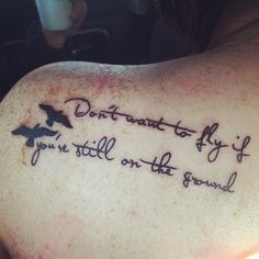 a woman with a tattoo on her shoulder saying don't fly if you're still on the ground