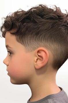 Faded sides paired with waves on top create a hairstyle that combines skin fade with natural waves. The wavy top adds an element and applying some salt spray enhances the texture further. Click here to check out more trendiest boys haircuts for school. Toddler Boy Haircut Long On Top, Boys Barber Haircut, Youth Boys Haircut, Young Boys Haircut Long On Top, Curly Boys Haircuts, Toddler Fade Haircut, Short Boys Haircut Trendy