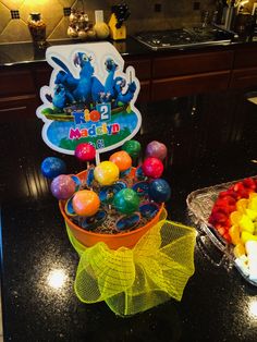 an assortment of candies and candy on a counter in a kitchen with a birthday sign