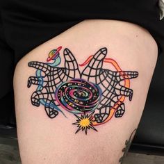 a woman's thigh with an abstract tattoo design on it