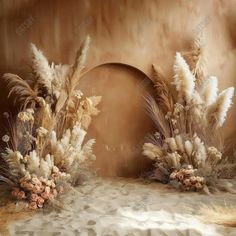 some very pretty flowers and plants in front of a brown wall with a circular doorway