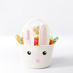 a small white basket with an easter bunny in it