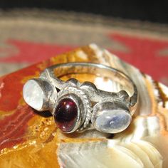 Sterling Cabochon Garnet & Blue Flash Moonstone Ring, Size 6, 6 grams. Garnet Ring Silver, Three Necklaces, Tacoma Wa, Garnet Ring, Hand Jewelry, Fantasy Jewelry, Garnet Rings, Moonstone Ring, Ring Silver