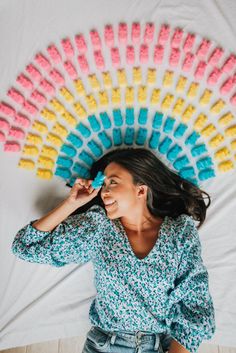 a woman laying on top of a bed with lots of macaroni and cheese