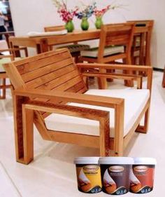 wooden chairs and tables in a room with white tile flooring on the floor, along with vases filled with flowers