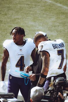 two football players standing next to each other