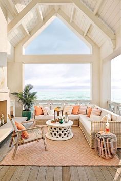 a living room filled with furniture and a fire place next to the ocean on instagram