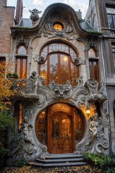 an elaborately designed entrance to a building with lots of windows and plants on the outside