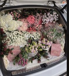 the trunk of a car filled with flowers