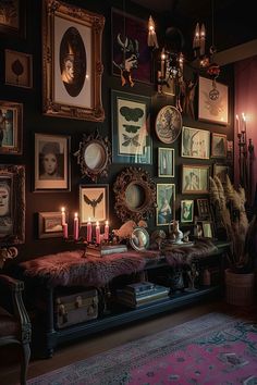 a room filled with pictures and candles on the wall next to a bench in front of a rug