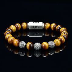 Genuine Tiger Eye Bead Bracelet for Men or Women Blue Steel Cable Custom Silver Magnetic Clasp Custom Silver Beads 10mm - AAA Quality Tiger Eye Premium Bead Bracelet with round 10 millimeter blue tigers eye beads, silver logo beads combined with a silver logo magnetic clasp. Comes with a premium leather logo box. You will not find the quality of beads I use which are 5A quality rated, the custom silver beads and high quality custom made silver clasp I use for my bracelets at any where close to t Mens Bead Bracelet, Mens Bracelet Designs, Bracelet Gift Box, Mens Gold Bracelets, Tiger Eye Bracelet, Gold Bead Bracelets, Blue Tigers Eye, Tigers Eye Gemstone, Silver Logo