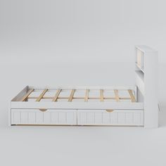 a white bed with two drawers underneath it