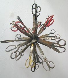 a bunch of scissors hanging from the ceiling