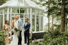 a bride and groom are standing in front of a gazebo with their wedding party