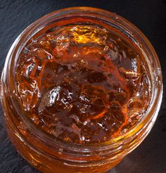 a glass jar filled with liquid sitting on top of a table