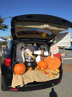 a trunk filled with pumpkins and decorations