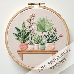 an embroidery project with flowers and plants in vases on a shelf, surrounded by text that reads hand embroid dairy pattern