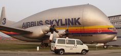 an airplane is parked next to a van