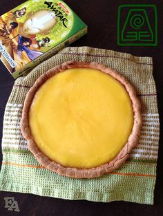 a yellow pie sitting on top of a table next to a box of jello