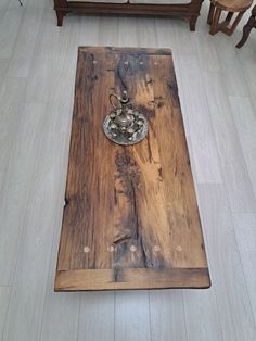 a coffee table made out of an old piece of wood with a candle holder on top