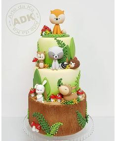 a three tiered cake decorated with animals and plants